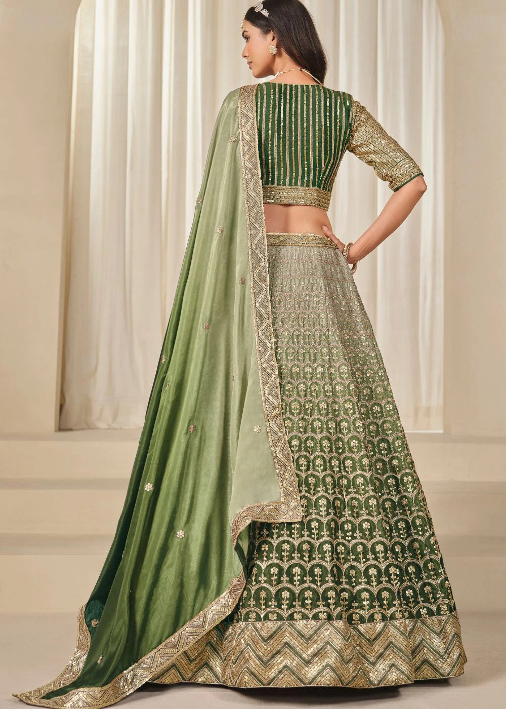 Emerald Royalty – Enchanted Green Chinon Silk Lehenga with Golden Zari Grandeur