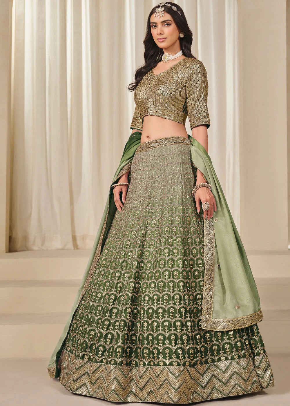 Emerald Royalty – Enchanted Green Chinon Silk Lehenga with Golden Zari Grandeur